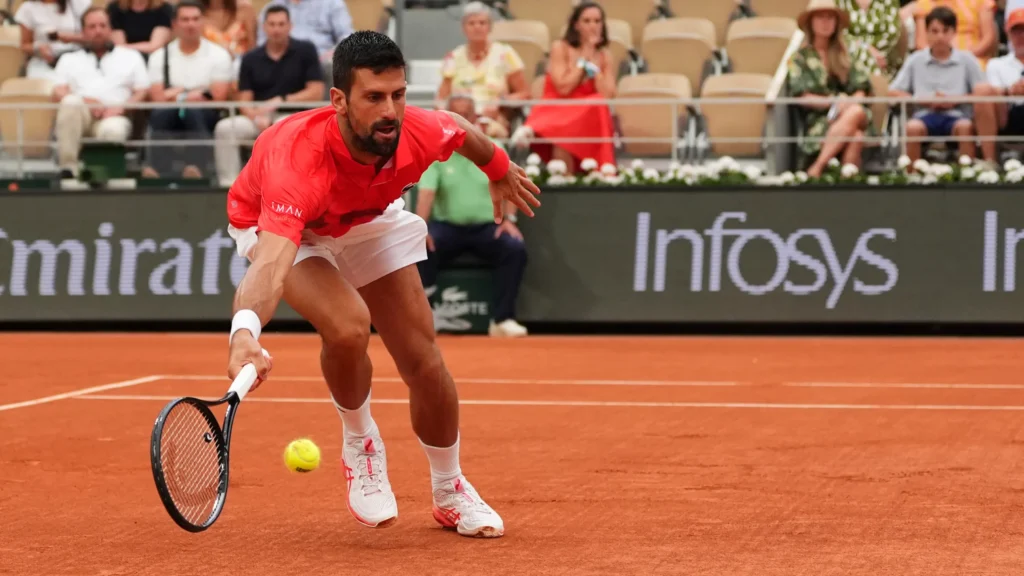 Novak Djokovic celebrates his straight-sets victory over Filip Misolic at Roland-Garros, showcasing dominant tennis skills.