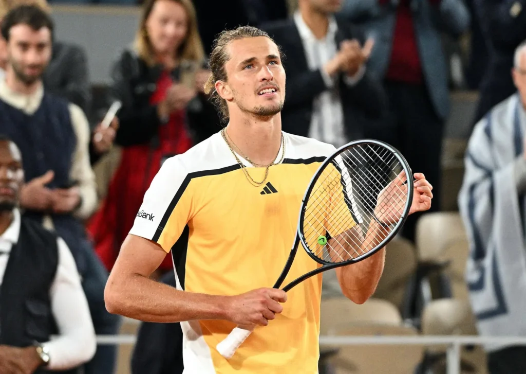 Alexander Zverev celebrates advancing to the Roland Garros quarterfinals after Griekspoor's injury retirement during their match.